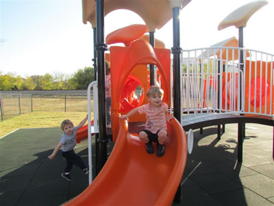 preschoolers playing at the playground slide