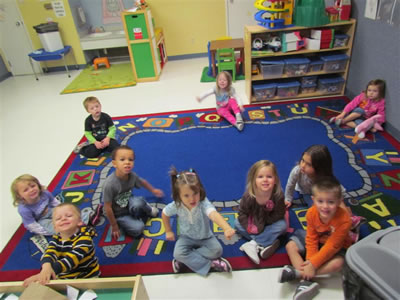 preschoolers sitting on a mat